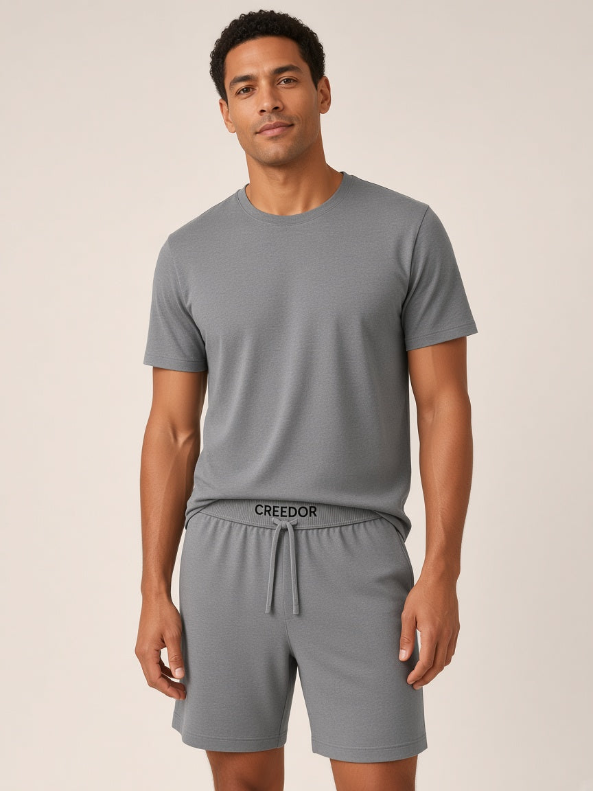 Model wearing CREEDOR lounge shorts in grey (concept render)