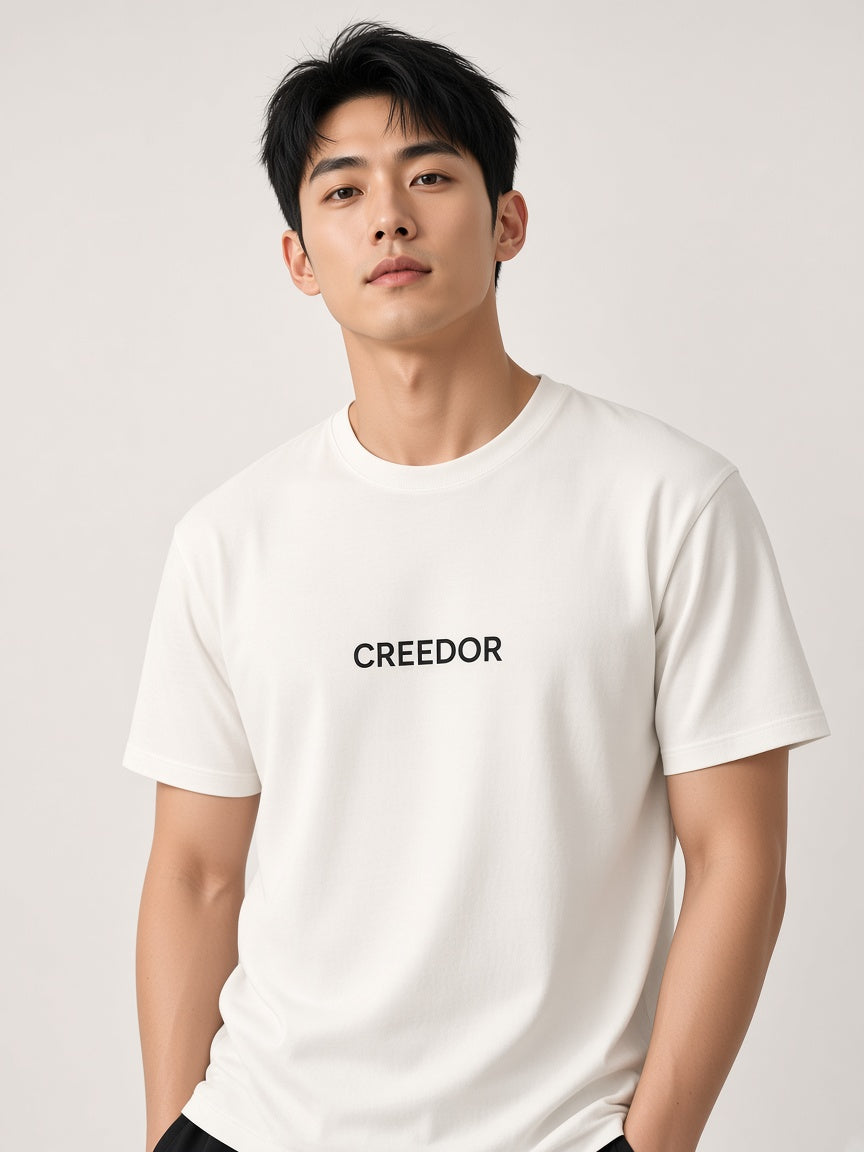 Model wearing the CREEDOR crew T-shirt in off-white (concept render)