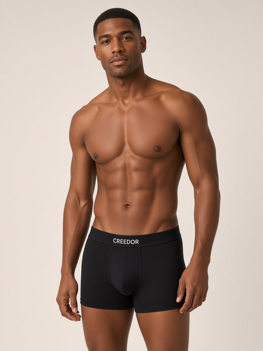 Model wearing CREEDOR men's boxer briefs in black (concept render)